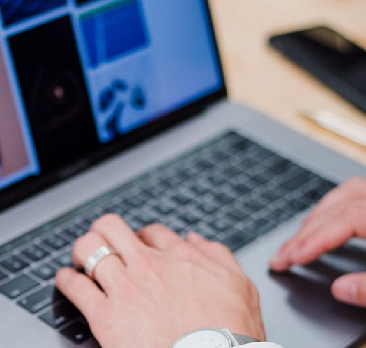 A person in Australia typing on a laptop computer using accounting software.